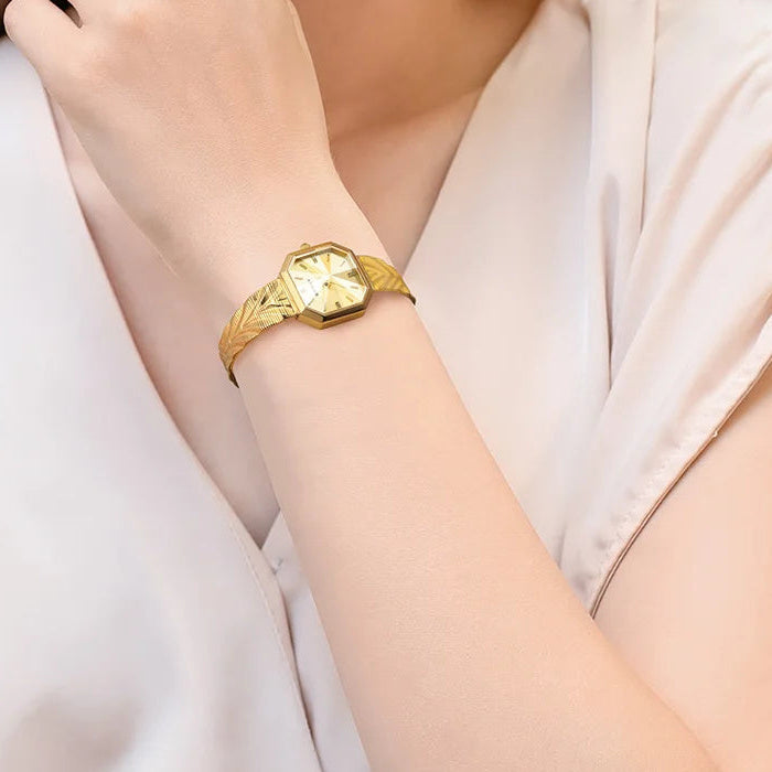 BERNY octagonal watch with gold dial and textured bracelet on a wrist