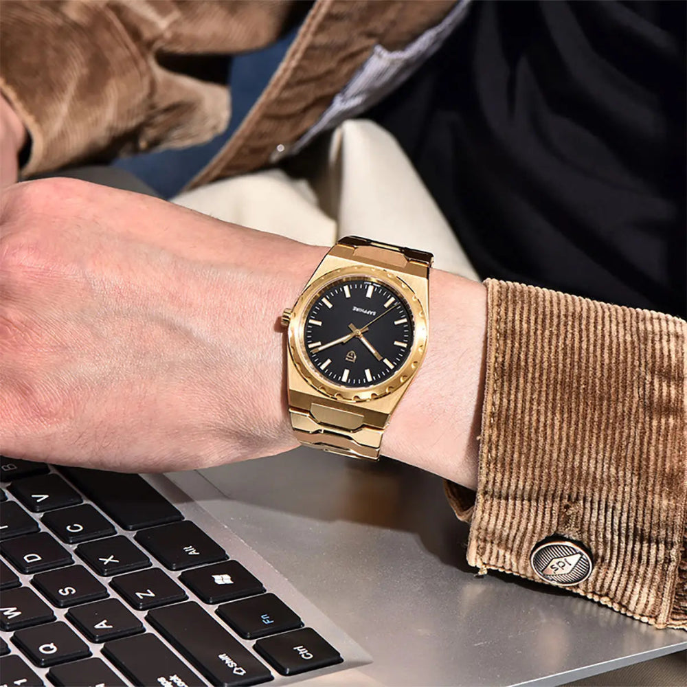Gold-tone Slim watch with a black dial worn with a brown corduroy jacket