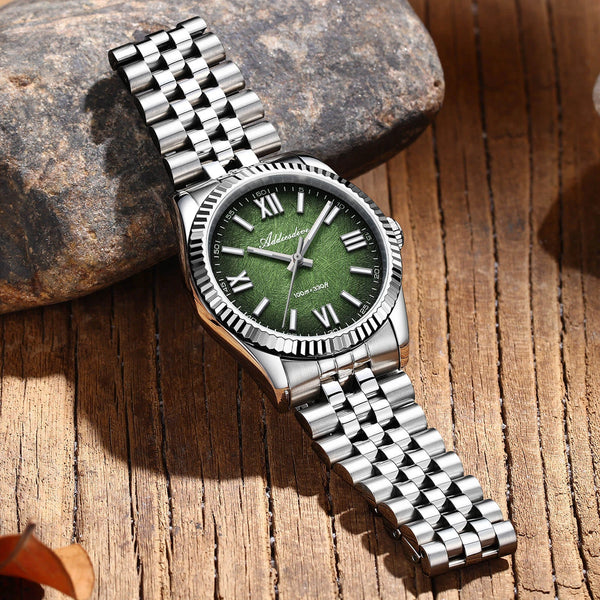 Calma green-dial watch with steel bracelet on stone and wood