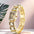 Gema watch with champagne gold crystal-link bracelet on a pink backdrop