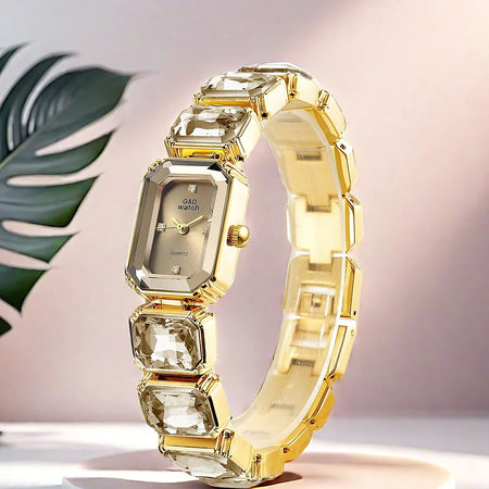 Gema watch with champagne gold crystal-link bracelet on a pink backdrop