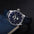 Starry blue aventurine dial moonphase watch with blue leather strap, angled on a dark background