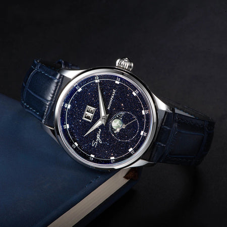 Starry blue aventurine dial moonphase watch with blue leather strap, angled on a dark background